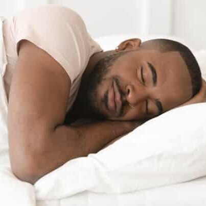 shutterstock_1455947342 Man sleeping in bed