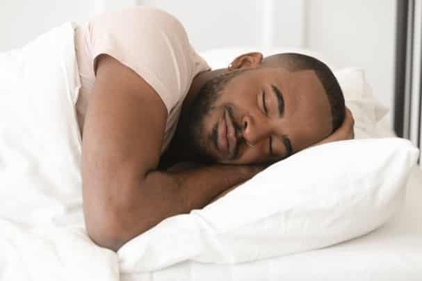 shutterstock_1455947342 Man sleeping in bed
