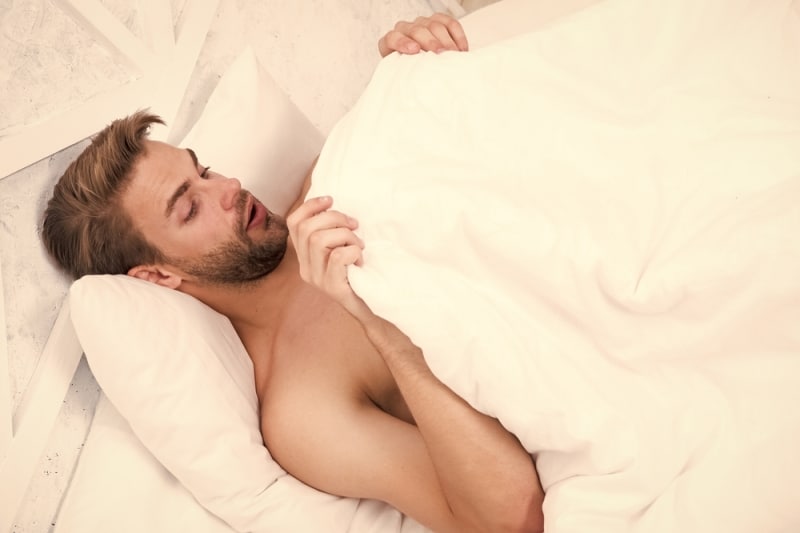 Man looking under the covers at his morning wood